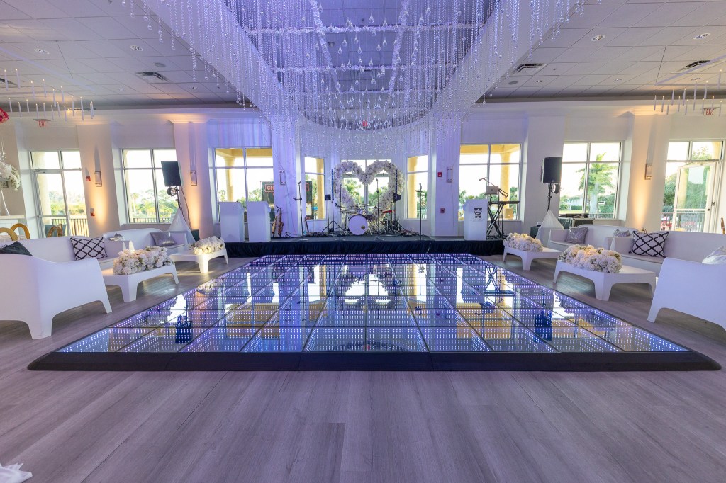 West Palm Beach Wedding Venue, waterfront wedding venue, Southern Florida wedding venue, West Palm Beach wedding ceremony, West Palm Beach outdoor wedding ceremony, wedding chairs, sunshine, country club wedding, palm trees, green landscaping, luxury country club wedding, affordable country club wedding, wedding ballroom, wedding banquet, Florida wedding venue, luxury dance floor, wedding lounge seating, luxury wedding decor