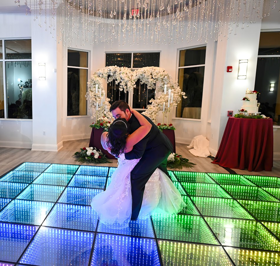 Palm Beach wedding venue reception bride and groom dance as a wedding photography takes photos.